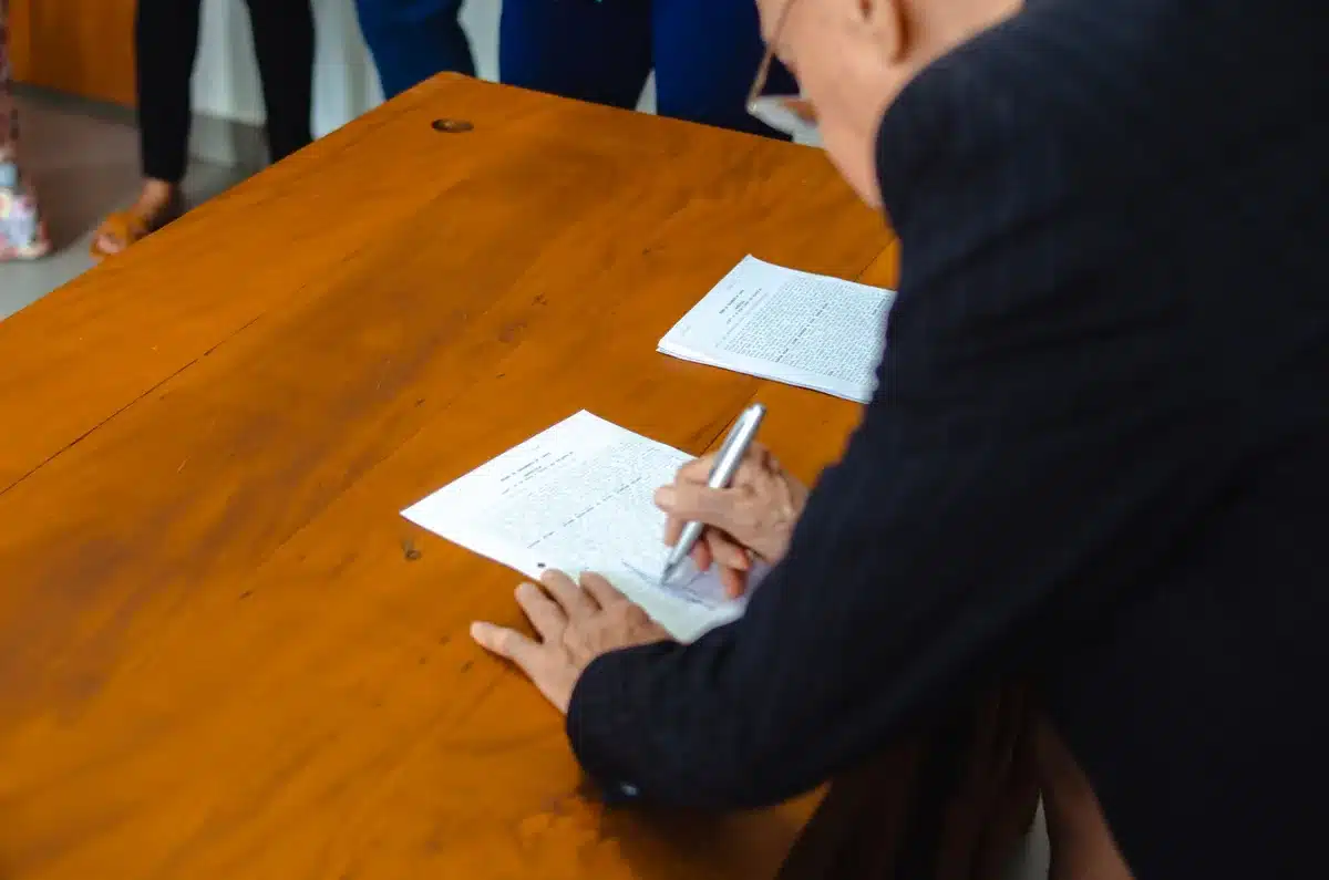 Documenti di trasferimento e contratti su una scrivania durante una trattativa di mercato