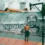 Giocatore di basket in posizione difensiva sotto canestro in arena moderna